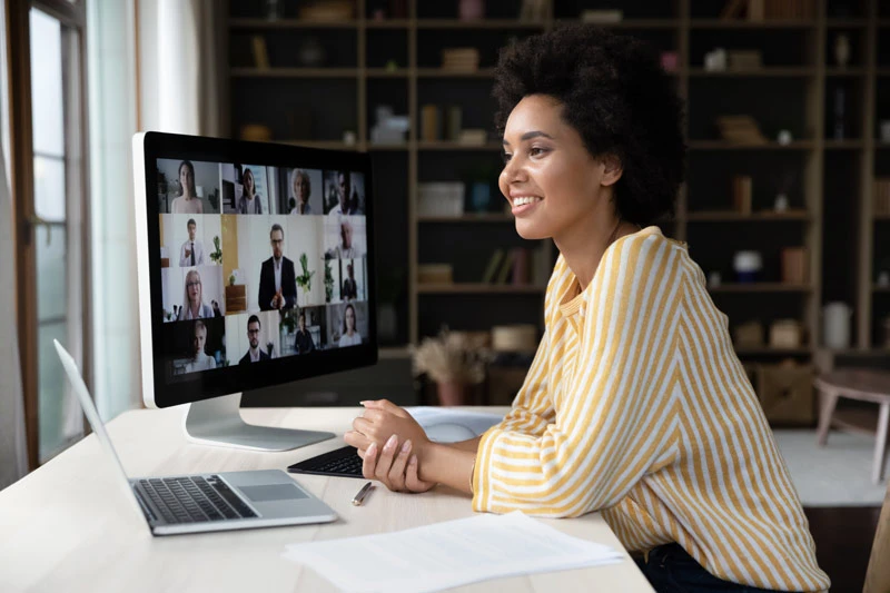 African American remote employee talking on video conference call to colleagues